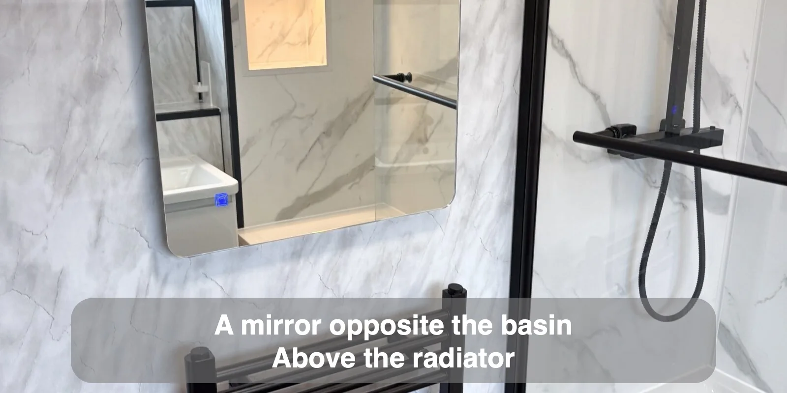 A mirror opposite the basin — Above the radiator