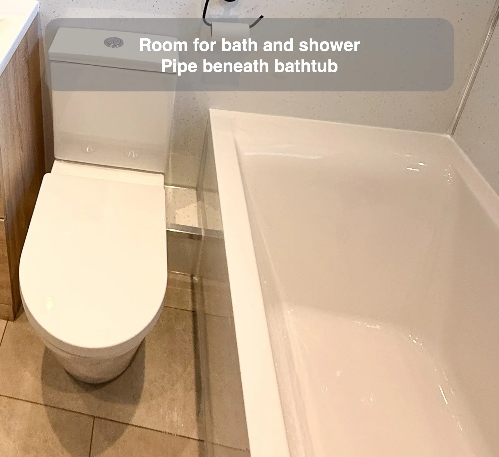 Room for bath and shower — Pipe beneath bathtub