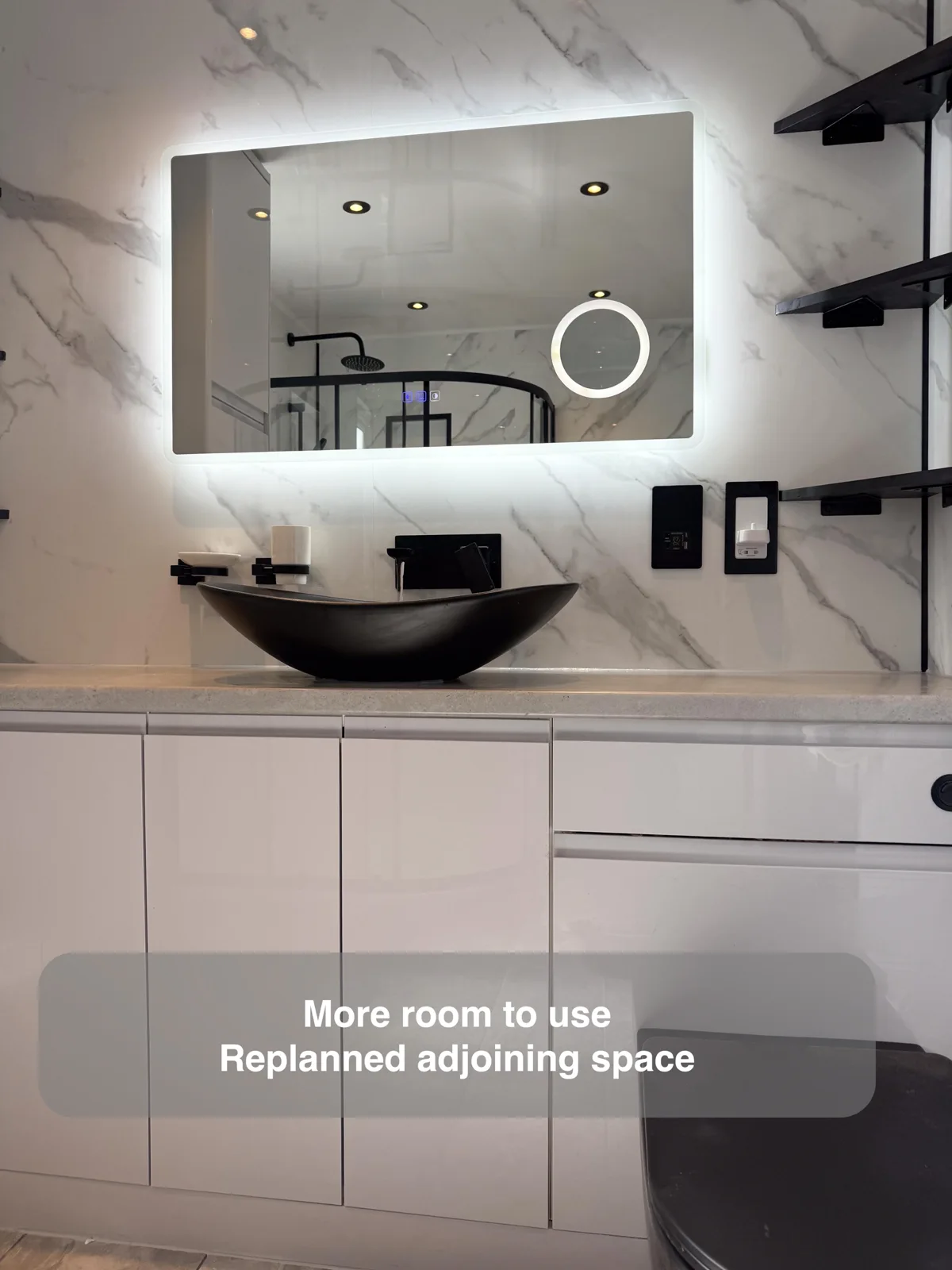 Look beyond the bathroom walls for extra space — completed bathroom project with benefit callouts