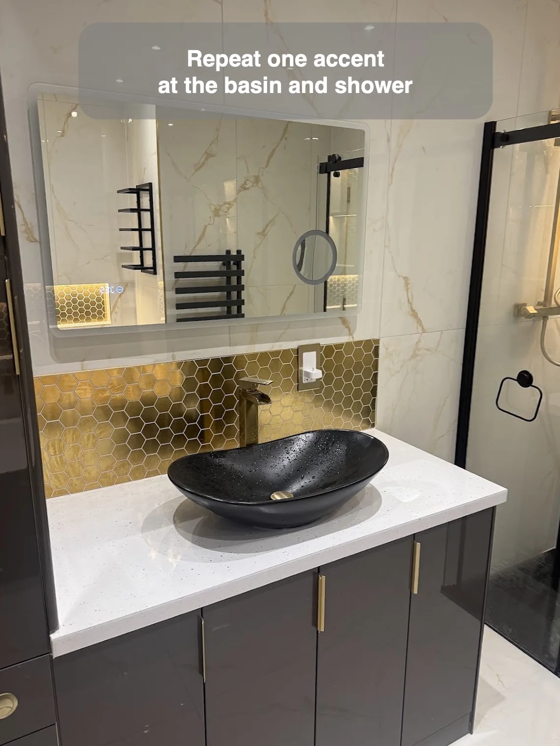 Gold hexagonal mosaic at the basin splashback and reflected shower recess