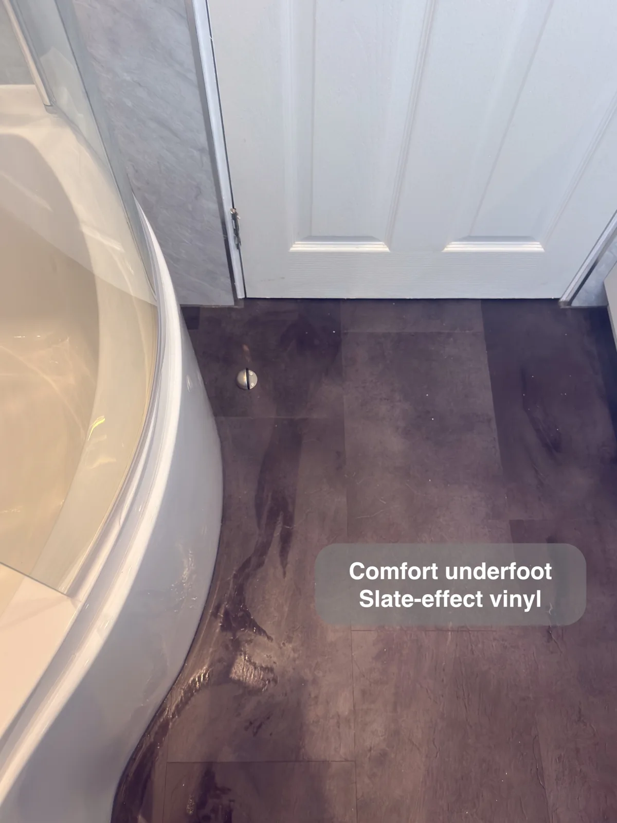 Aberdeen bathroom: floor detail slate effect beside curved bath