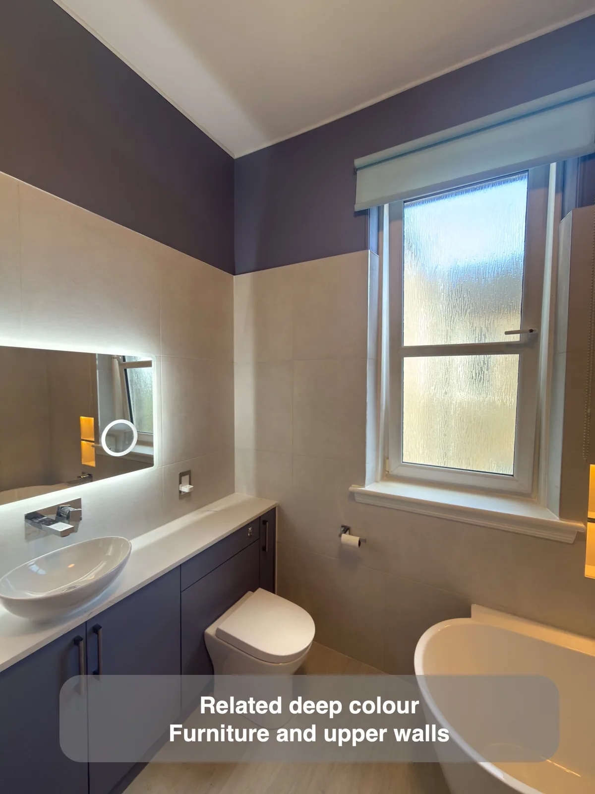 Deep plum fitted cupboards and related upper-wall colour above pale tiles.