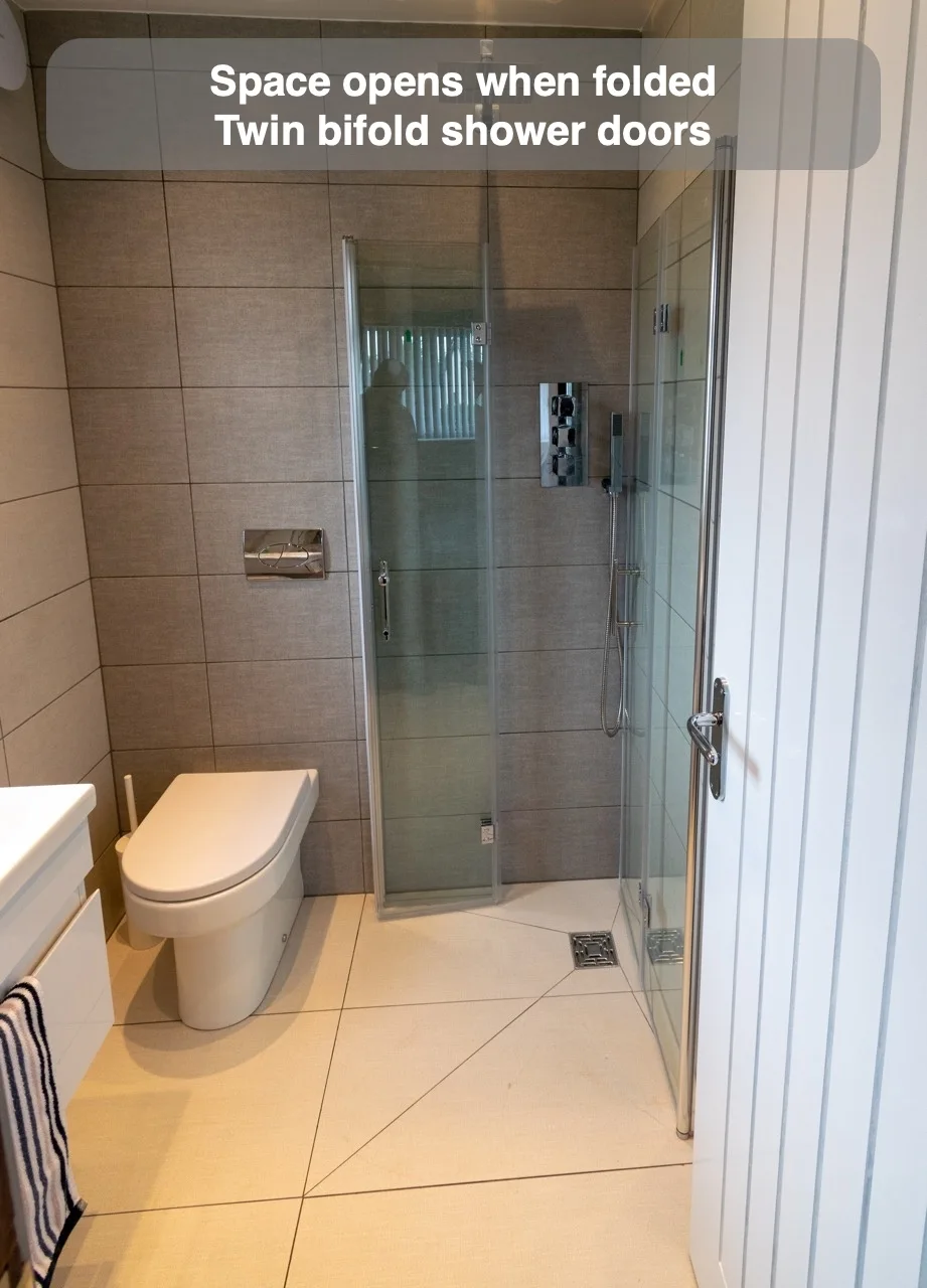 Space opens when folded — Twin bifold shower doors