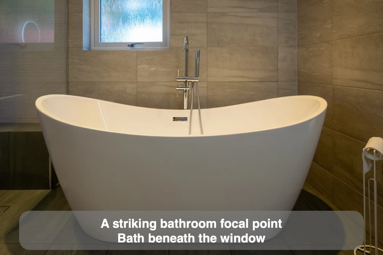 A striking bathroom focal point — Bath beneath the window