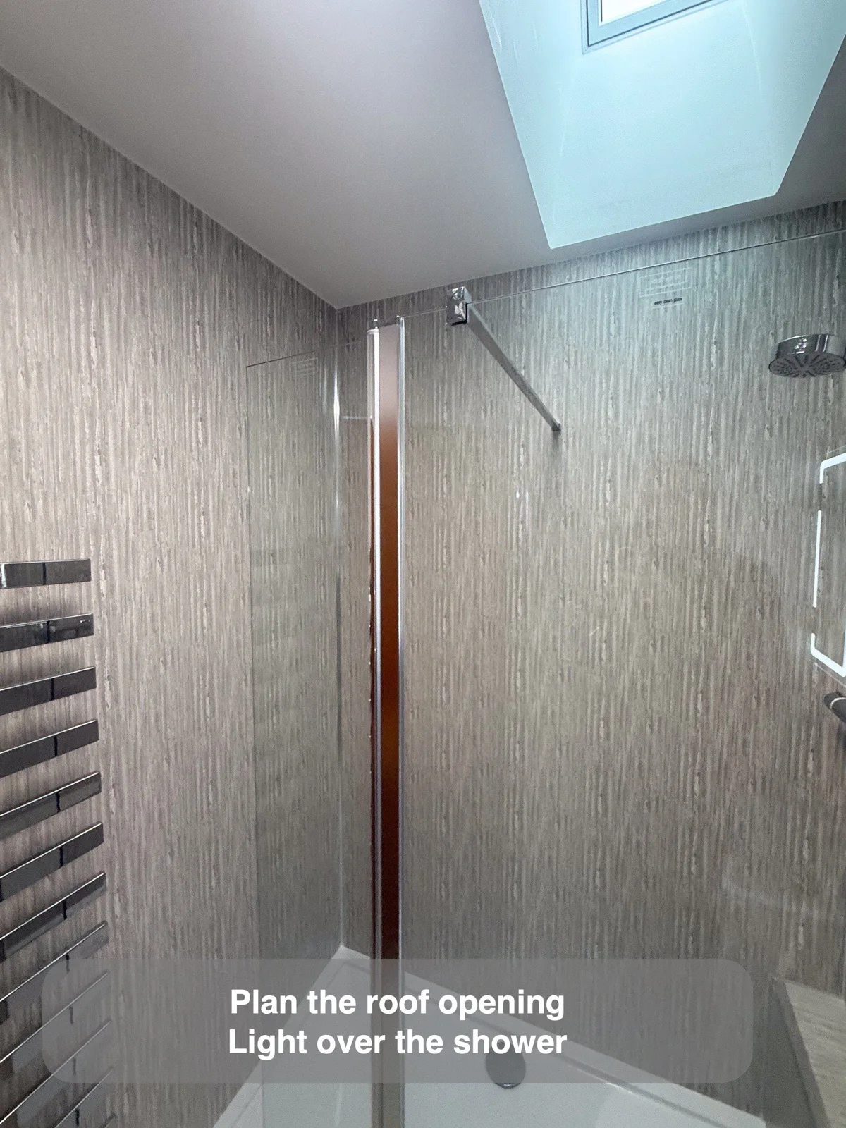 Rooflight above a shower enclosure in a sloping-ceiling bathroom.