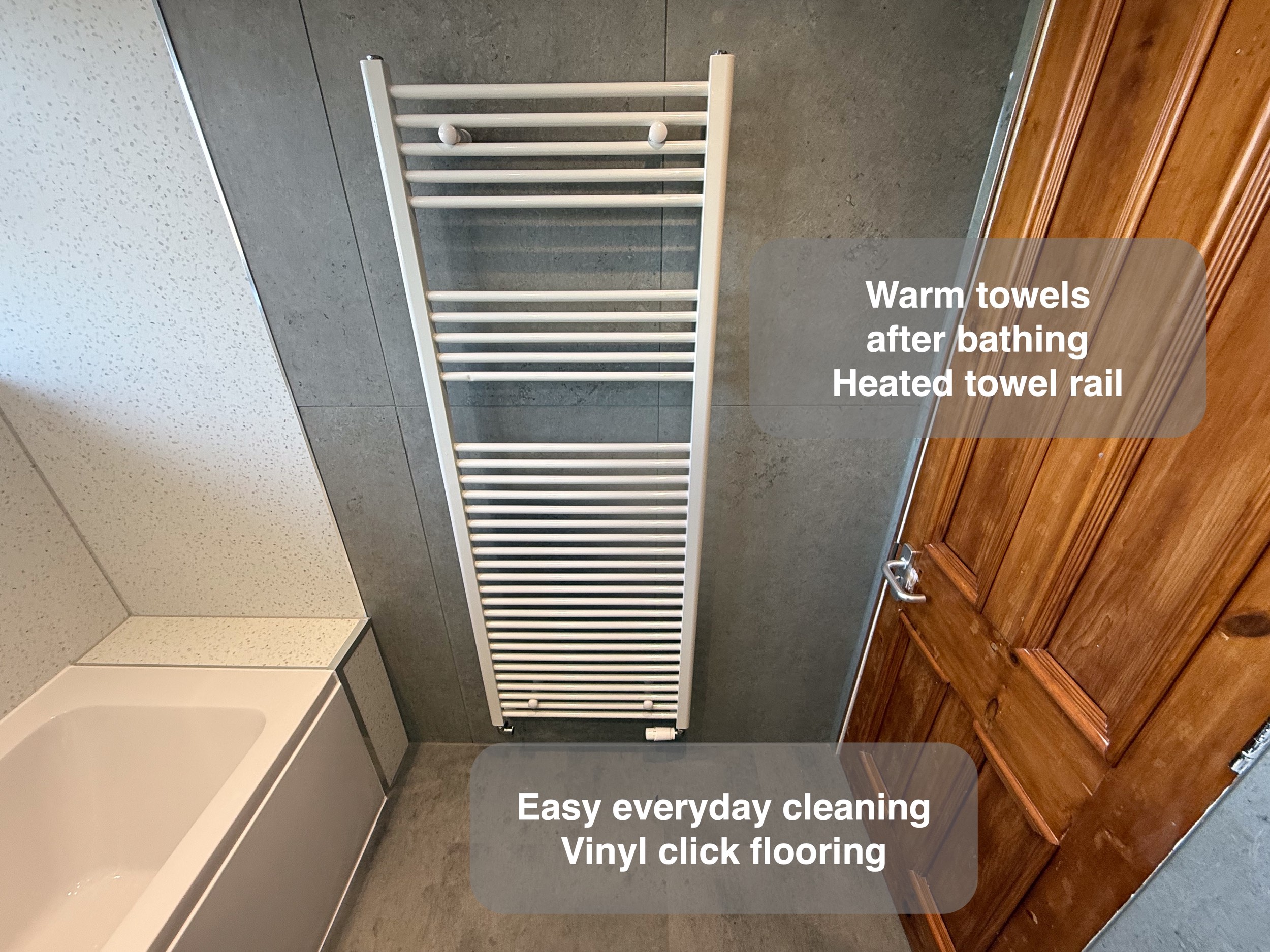 Heated towel rail in the completed Aberdeen bathroom, with benefit callouts.